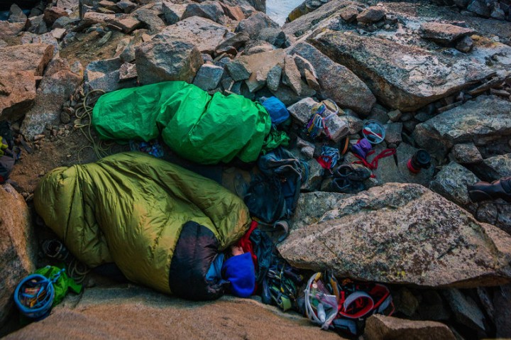 Meredith Jabis and Brian Russell get in their last winks of sleep at 14,000 ft (4,300 m) while the sunrises and illuminates the Sierra Nevada Range of California. They are traversing the Palisades which involves 5 summiting 5 14ers and seemingly endless knife blade ridge traversing (IV 5.9).