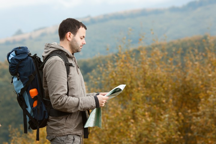 Tourist with a backpack in the mountains